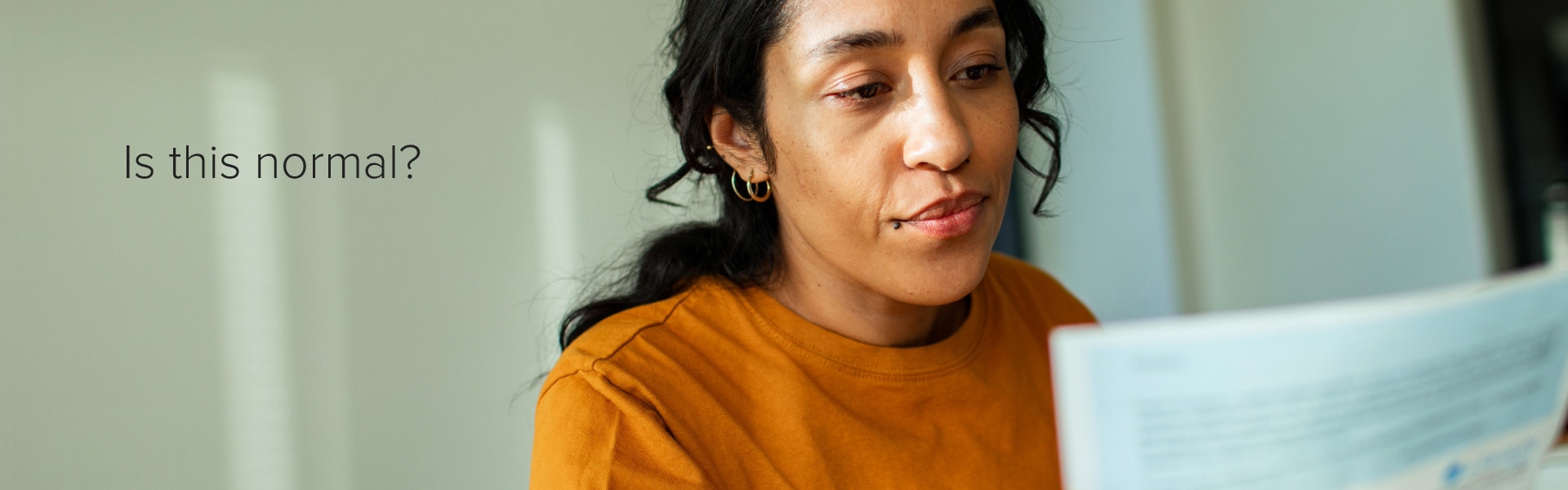 Woman reviewing lab results at home with the text “Is this normal?”