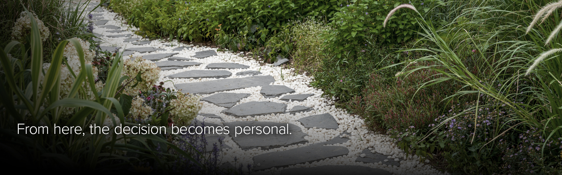 Stone garden path winding through greenery, representing a calm, step-by-step personal decision process